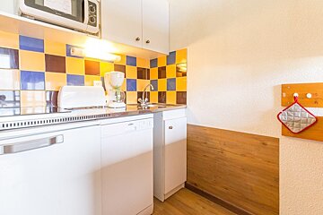 A kitchen with a dishwasher a toaster and a microwave
