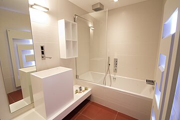 A bathroom with a bathtub and a sink