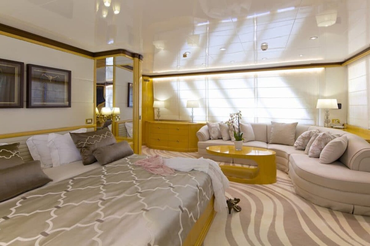 A bedroom with a large bed and a couch