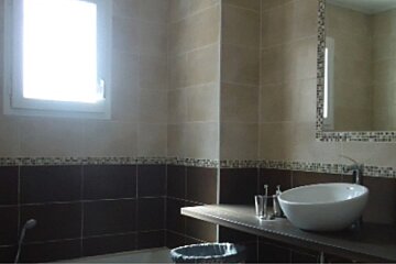 A bathroom with a sink a mirror and a window