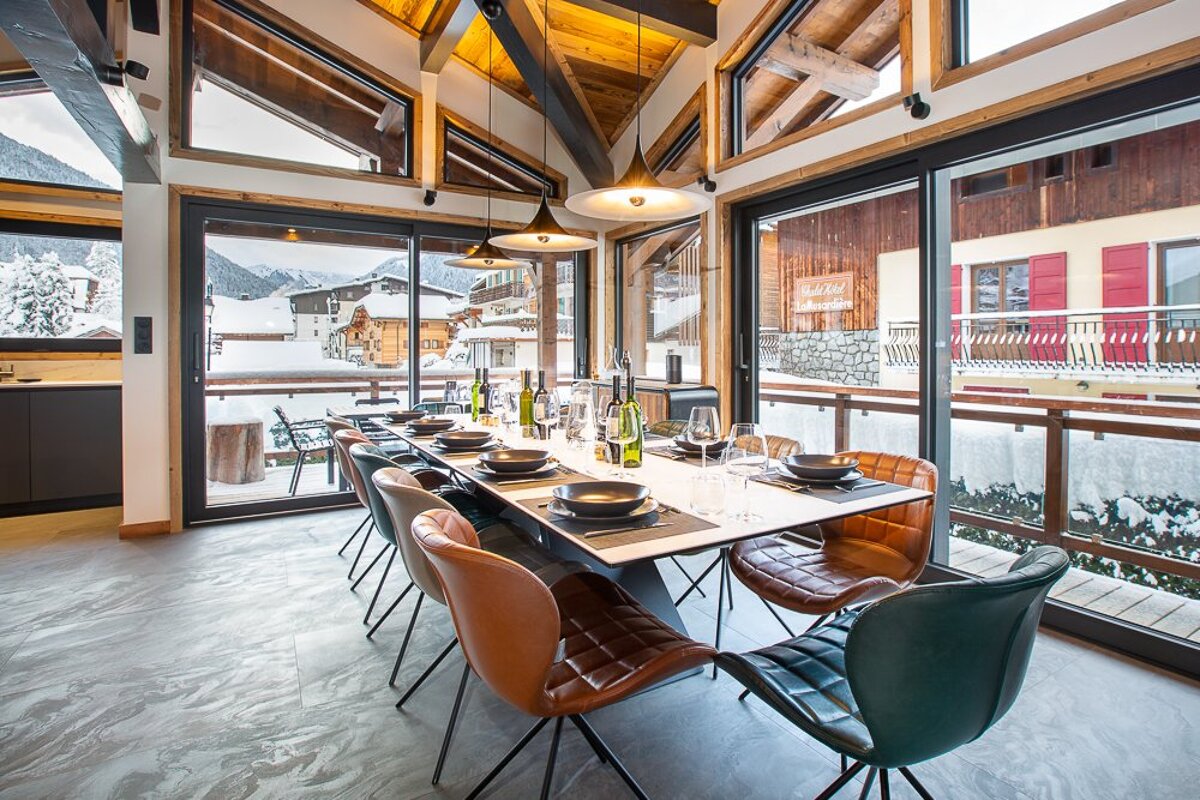 A dining room with a table and chairs and a sign that says ' altitude ' on it