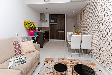 A living room with a couch and two coffee tables