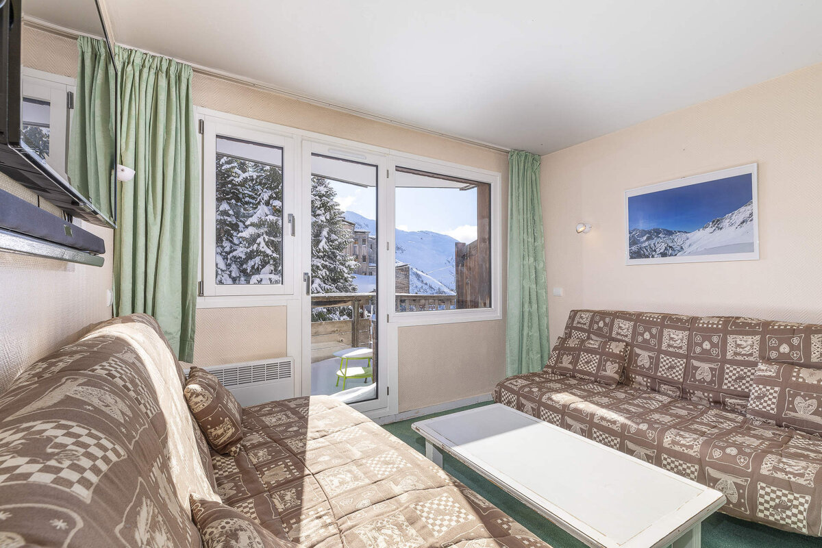 A living room with a couch and a picture on the wall