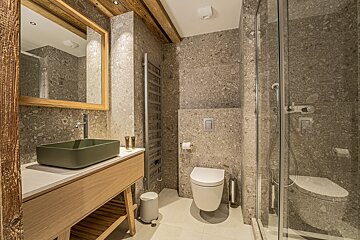 A bathroom with a green sink and a white toilet