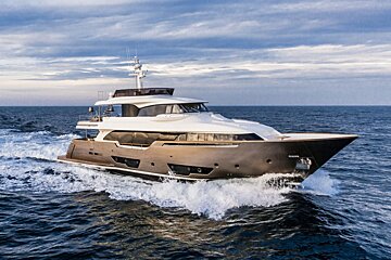 A large yacht is floating on top of a body of water