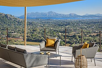 A patio with a view of mountains and a lake
