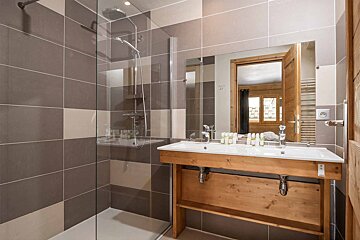 A bathroom with a sink and a walk in shower