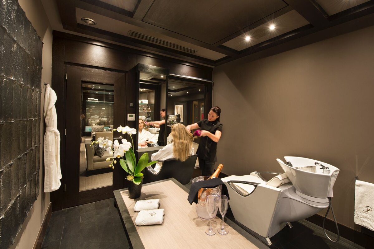 A woman is getting her hair done in a salon