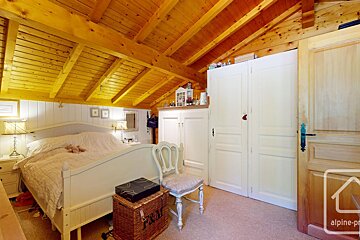 A bedroom with a bed and a trunk that says p & n on it