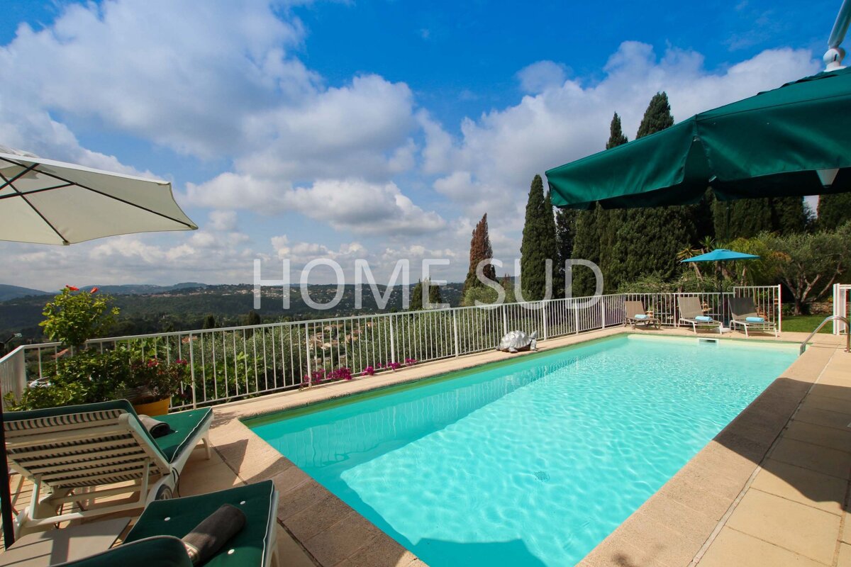 A large swimming pool surrounded by chairs and umbrellas is for sale by home sud