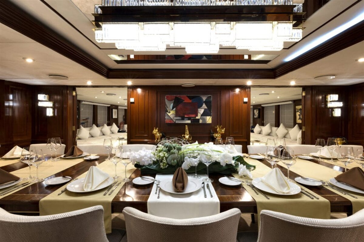 A large dining room with a painting on the wall