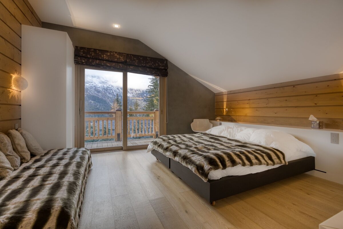 A bedroom with a large bed and a couch