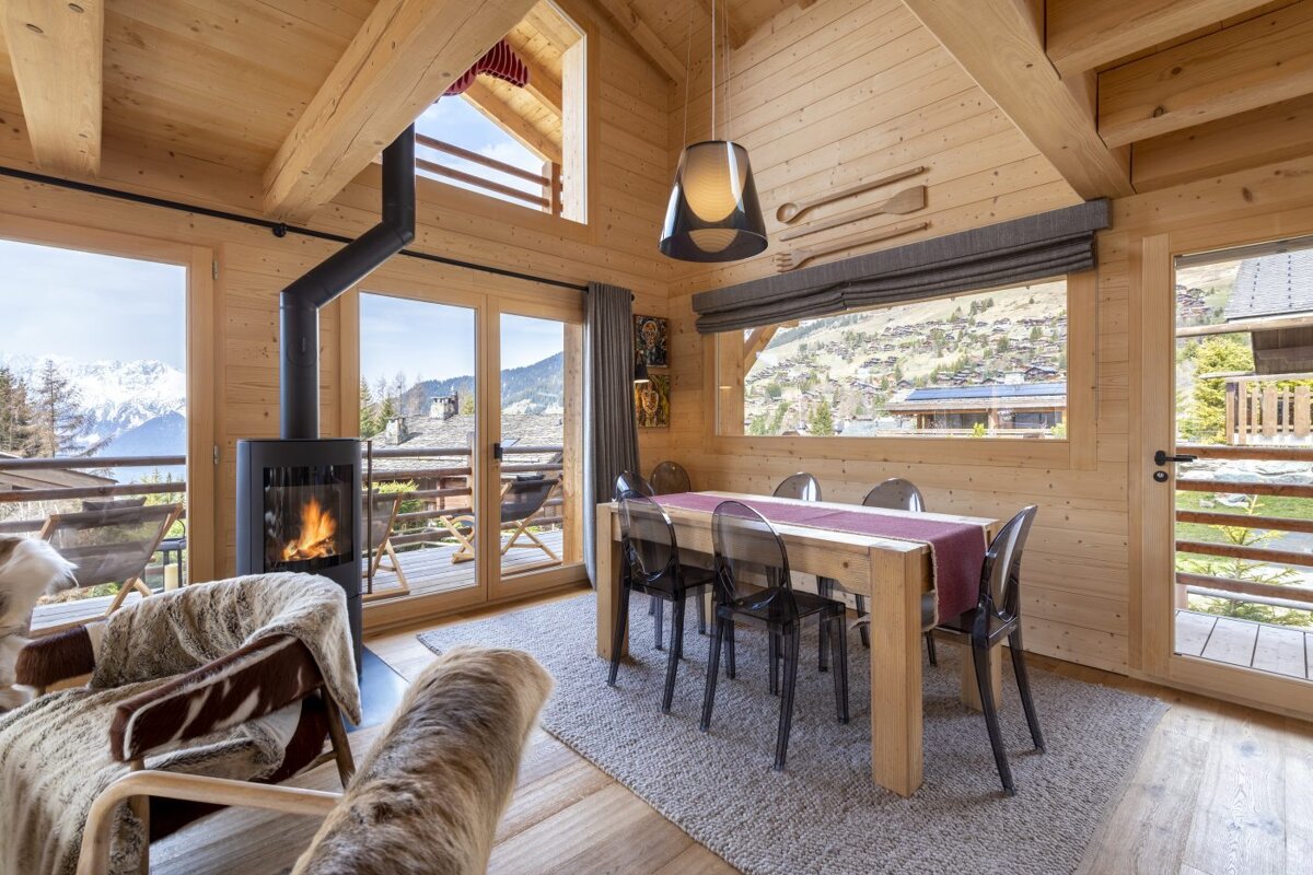 A living room with a table and chairs and a fireplace
