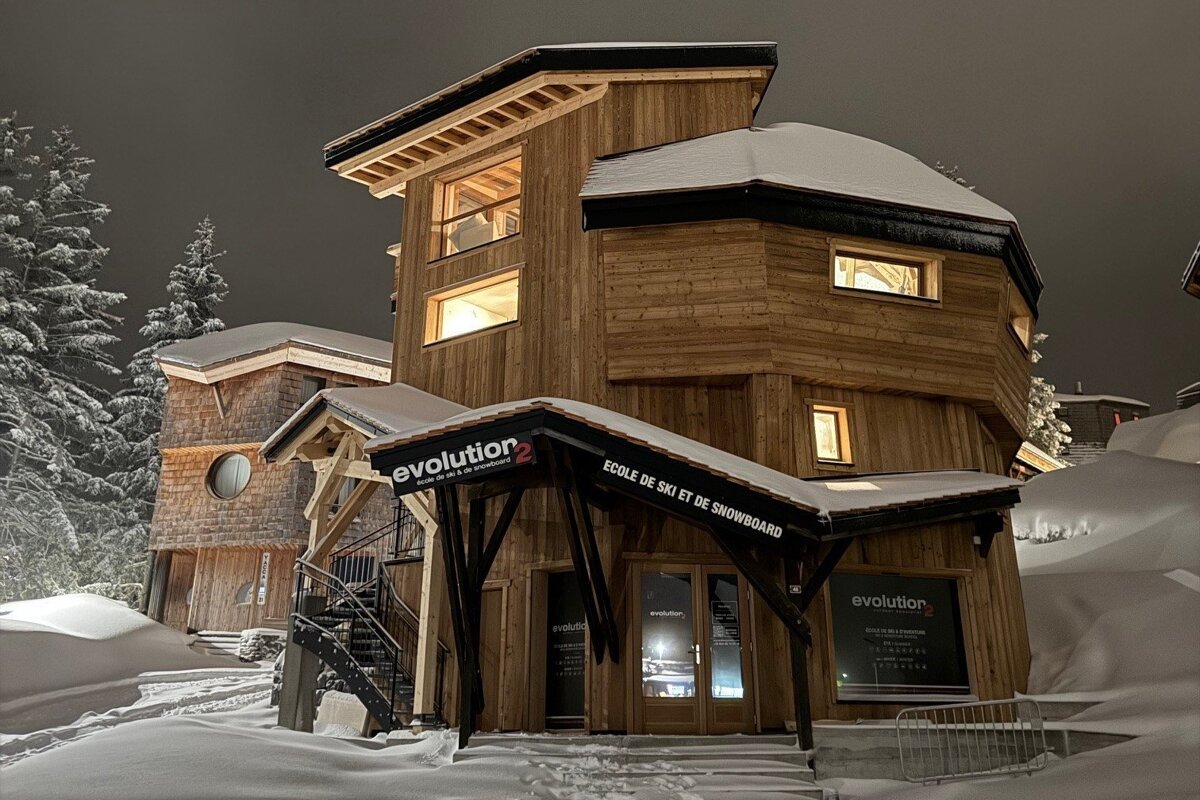 A snow-covered wooden ski school, 