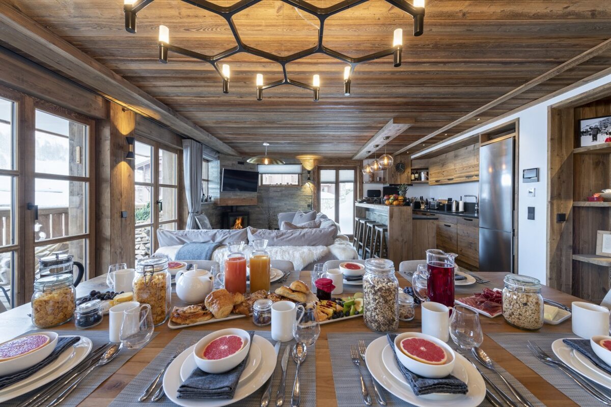 A dining table with plates and bowls of food on it