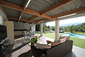A living room with a couch and a flat screen tv