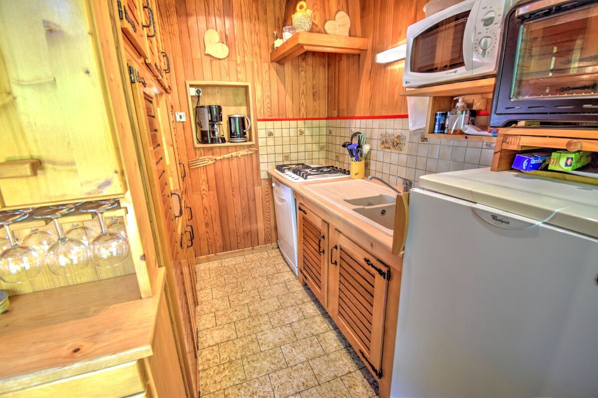 A kitchen with a whirlpool refrigerator and a microwave