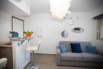 A living room with a couch and a blue box with flowers on it