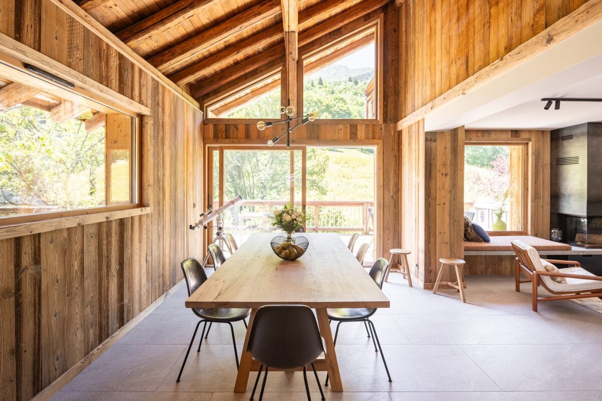 A dining room with a wooden table and chairs