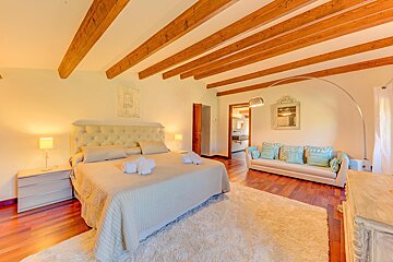 A bedroom with a king size bed and a couch