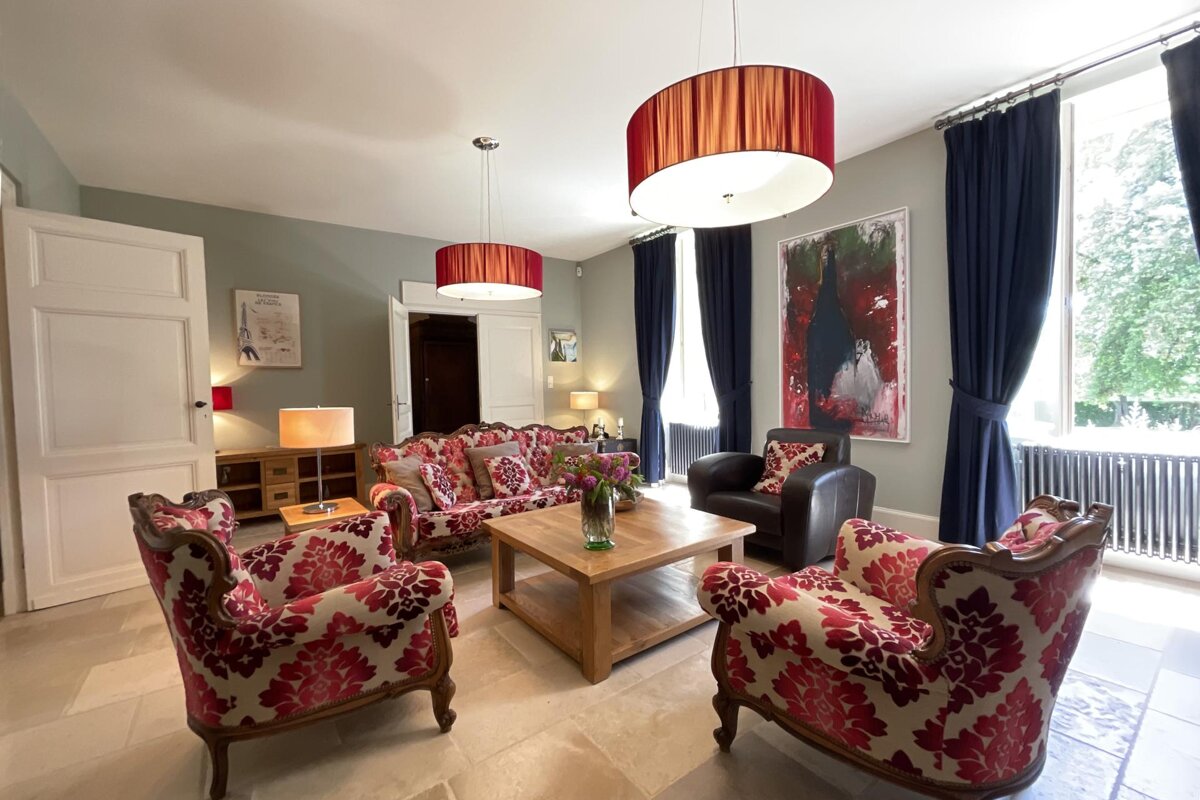 A living room with a couch and two chairs