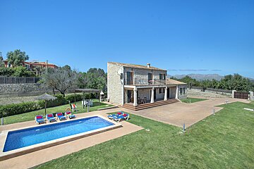 A large house with a large swimming pool in front of it