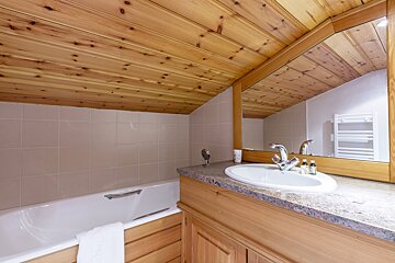 A bathroom with a bathtub and a sink