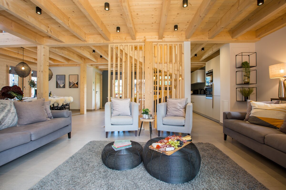 A living room with a couch and two chairs