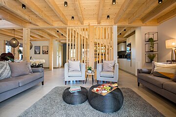 A living room with a couch and two chairs