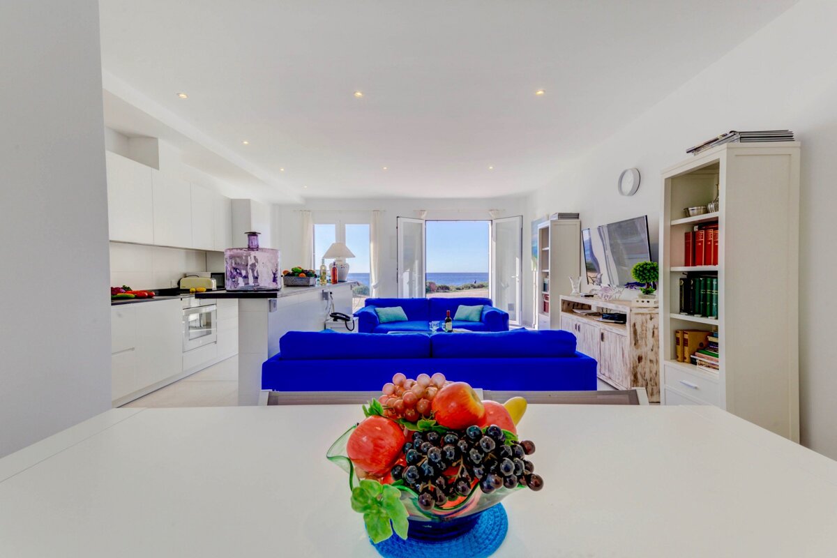 A bowl of fruit sits on a table in a living room