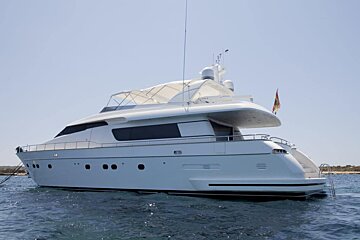 A large white yacht is floating in the water