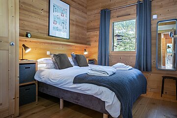 A bedroom with a bed and a clock on the wall