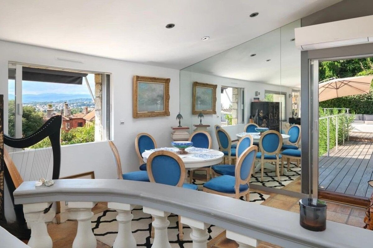 A harp sits in a room with a table and chairs