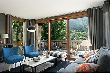 A living room with a couch two chairs and a coffee table