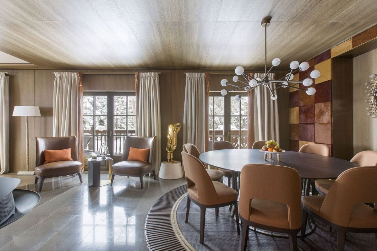 A dining room with a round table and chairs