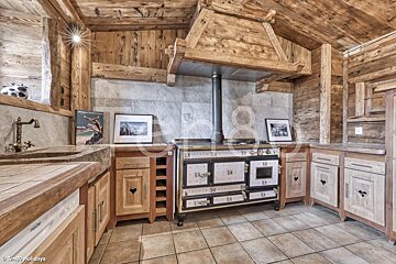 A kitchen with wooden cabinets and a stove that says holidays