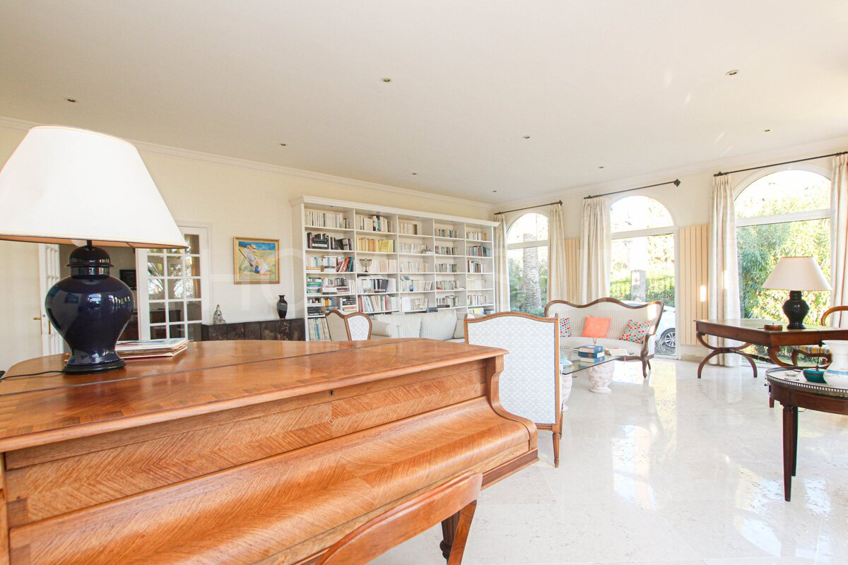 A living room with a piano and a lamp