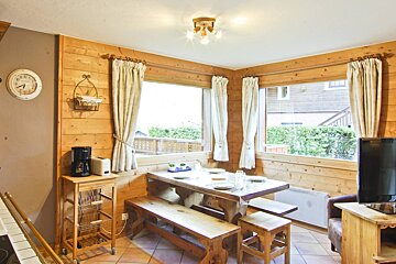 A kitchen with a clock on the wall that says ' a.m. ' on it