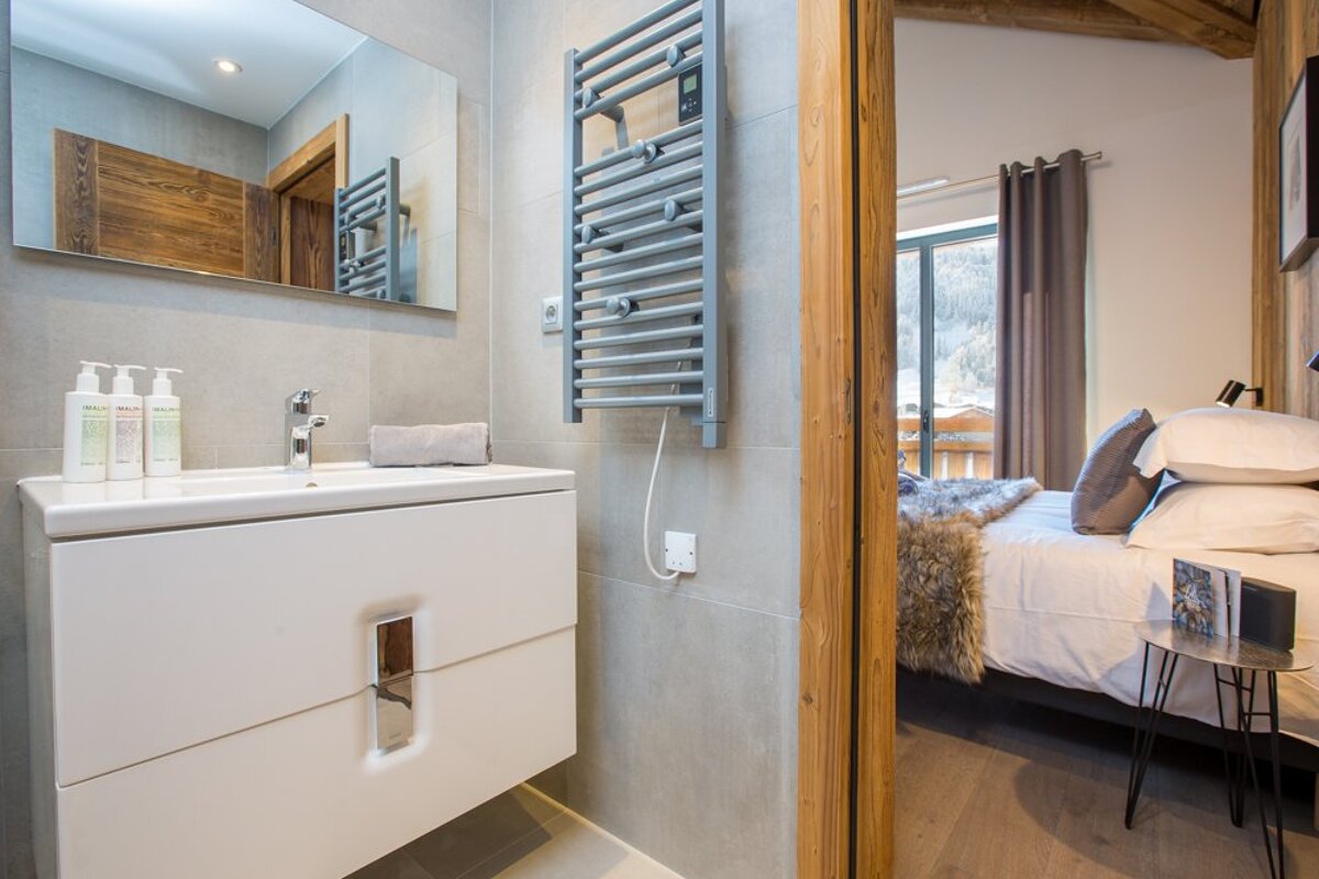 A bathroom with a sink and a towel rack