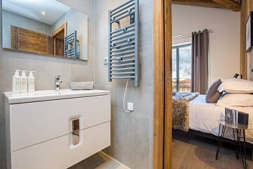 A bathroom with a sink and a towel rack