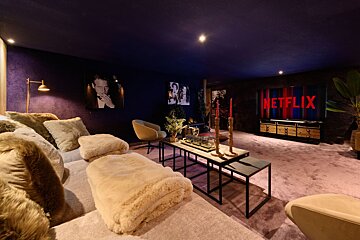 A living room with a netflix sign on the wall