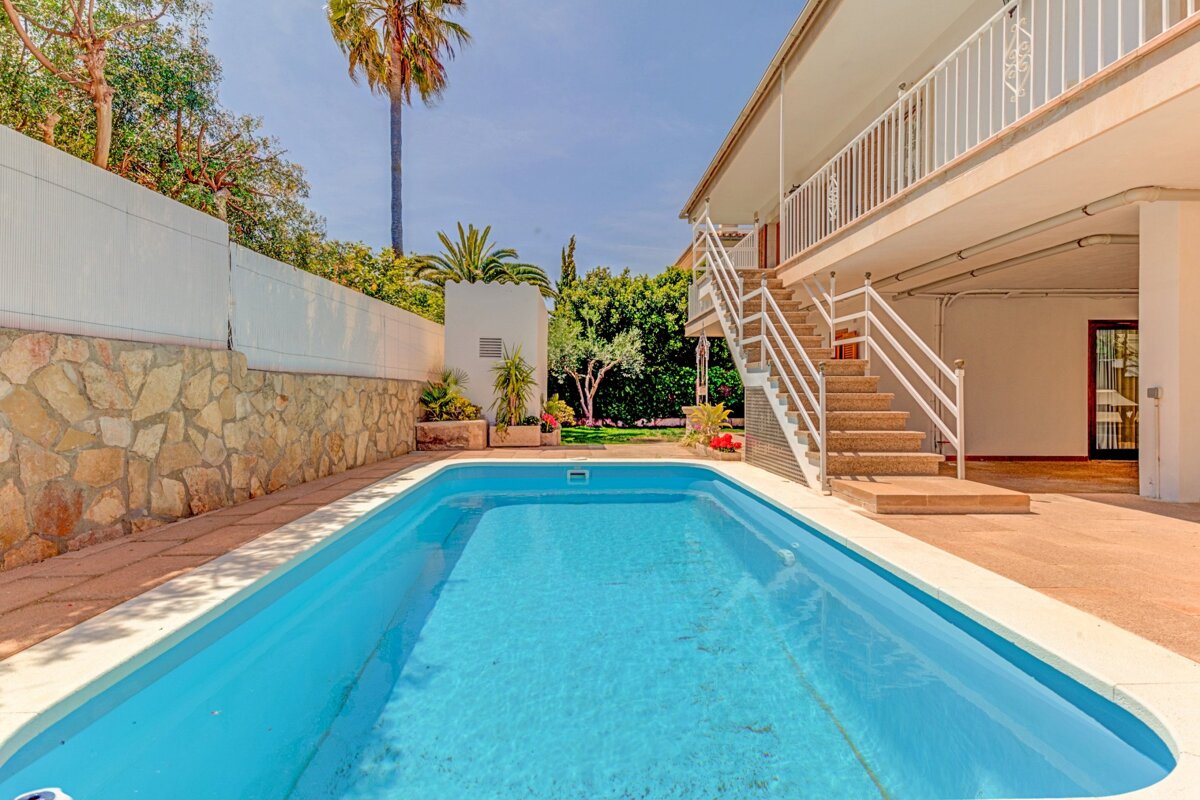 A large swimming pool with stairs leading up to it