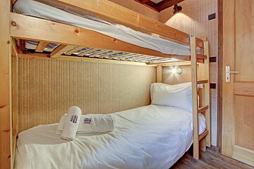 A bunk bed with a towel that says ' swiss ' on it