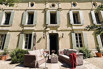 A large building with a lot of windows and shutters