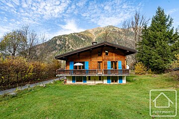 A house with blue shutters is for sale by alpine property