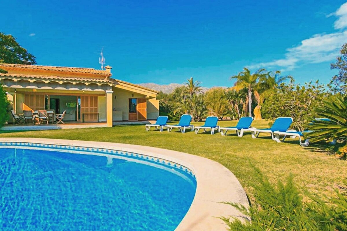 A house with a swimming pool in front of it