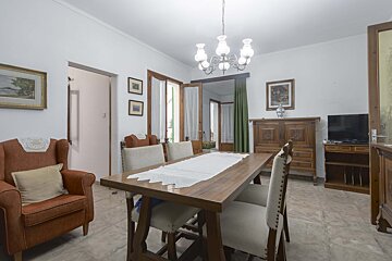 A living room with a dining table and chairs