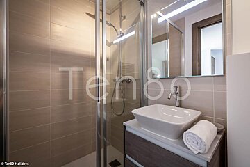 A bathroom with the word tengo on the wall