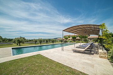 A large swimming pool with a canopy over it
