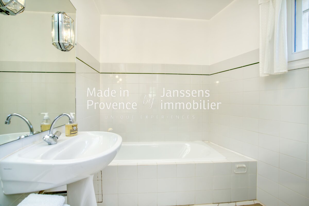 A bathroom with a sink and a bathtub made in provence by immobilier